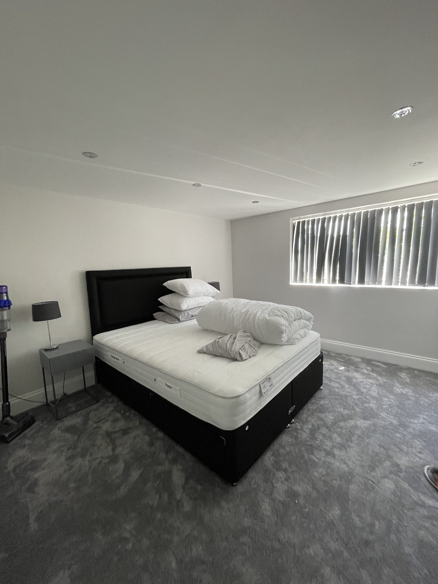 Finished bedroom with soft grey walls and white ceiling