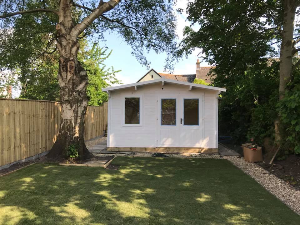 White painted garden room in a sunny garden