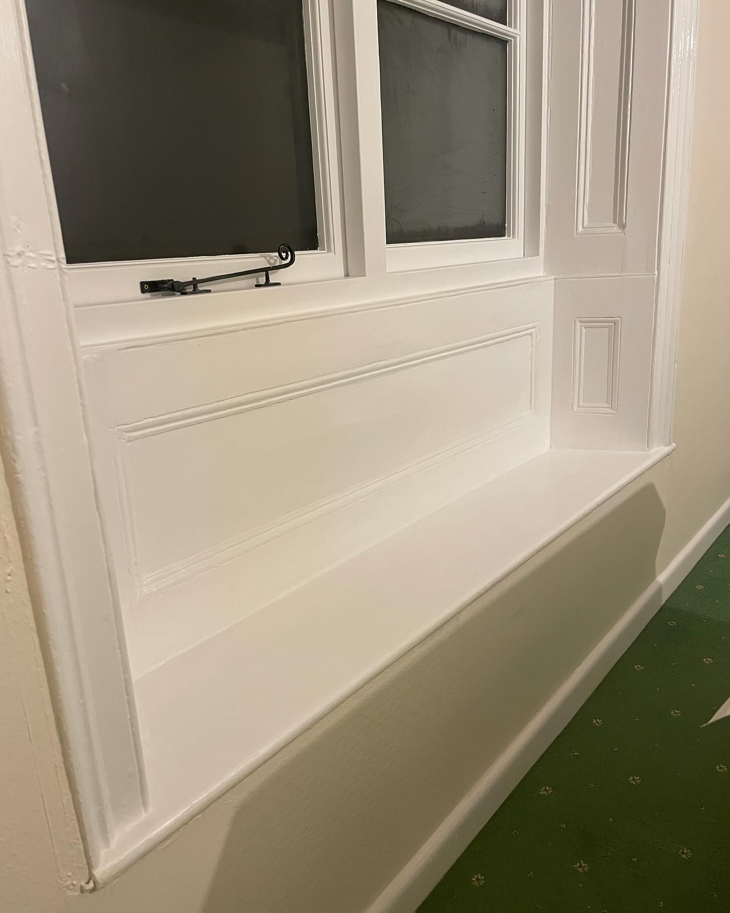 Panelled window seat painted crisp white